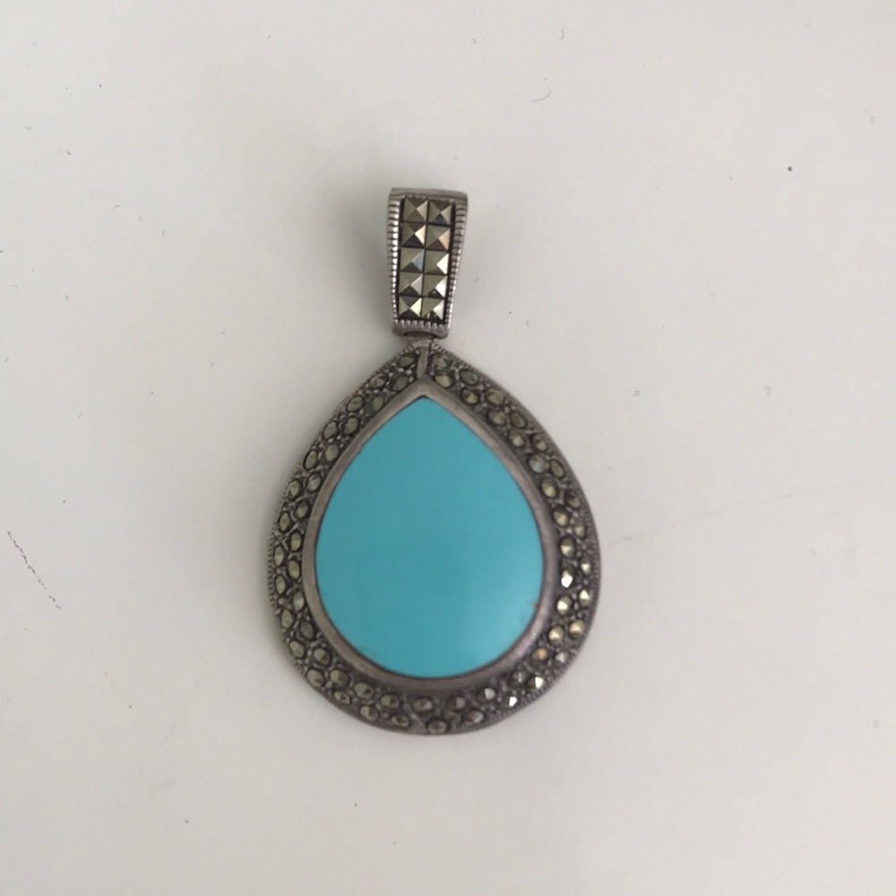 Turquoise and silver colored pendant